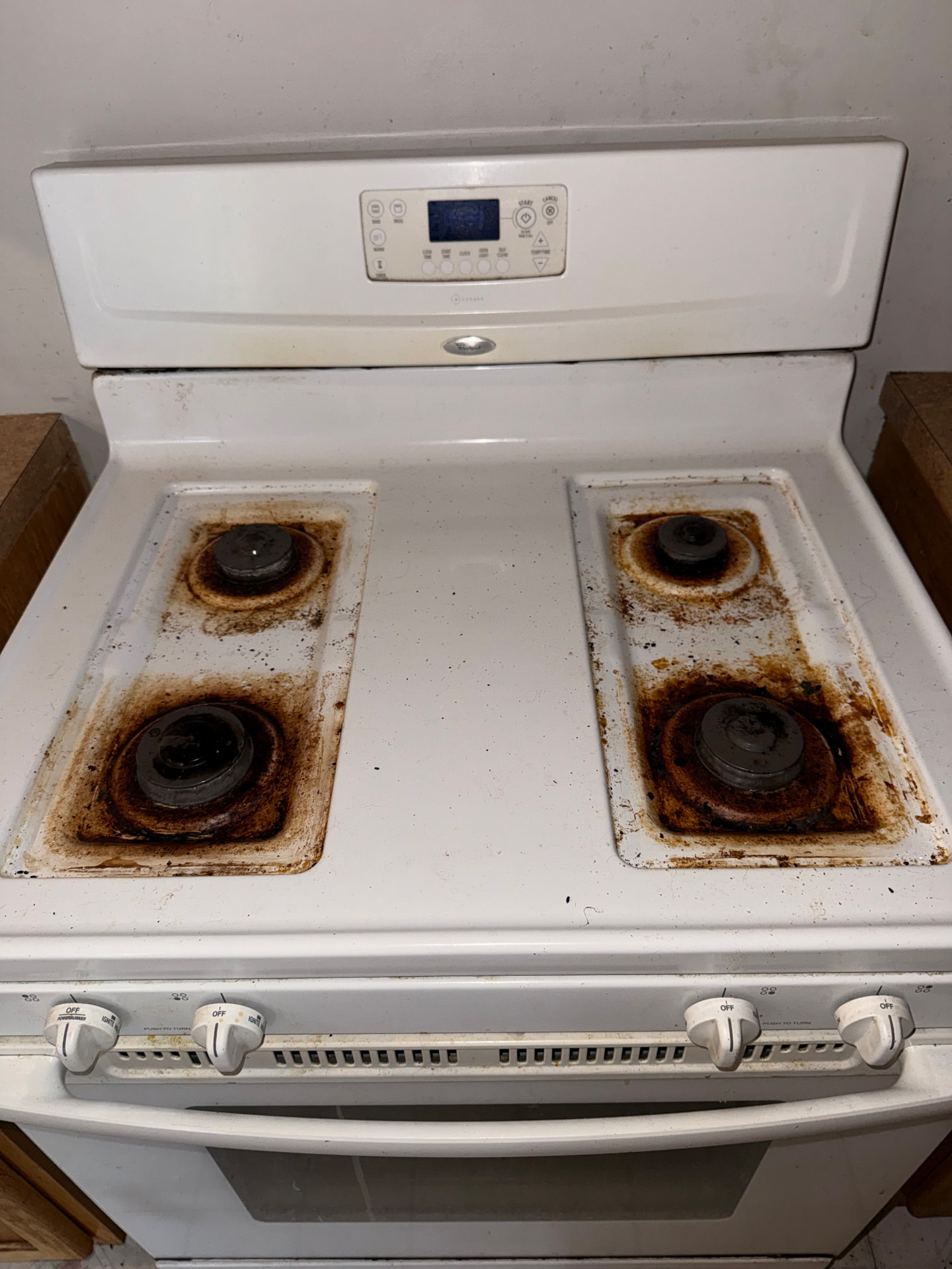 Greasy, stained stovetop before a deep clean