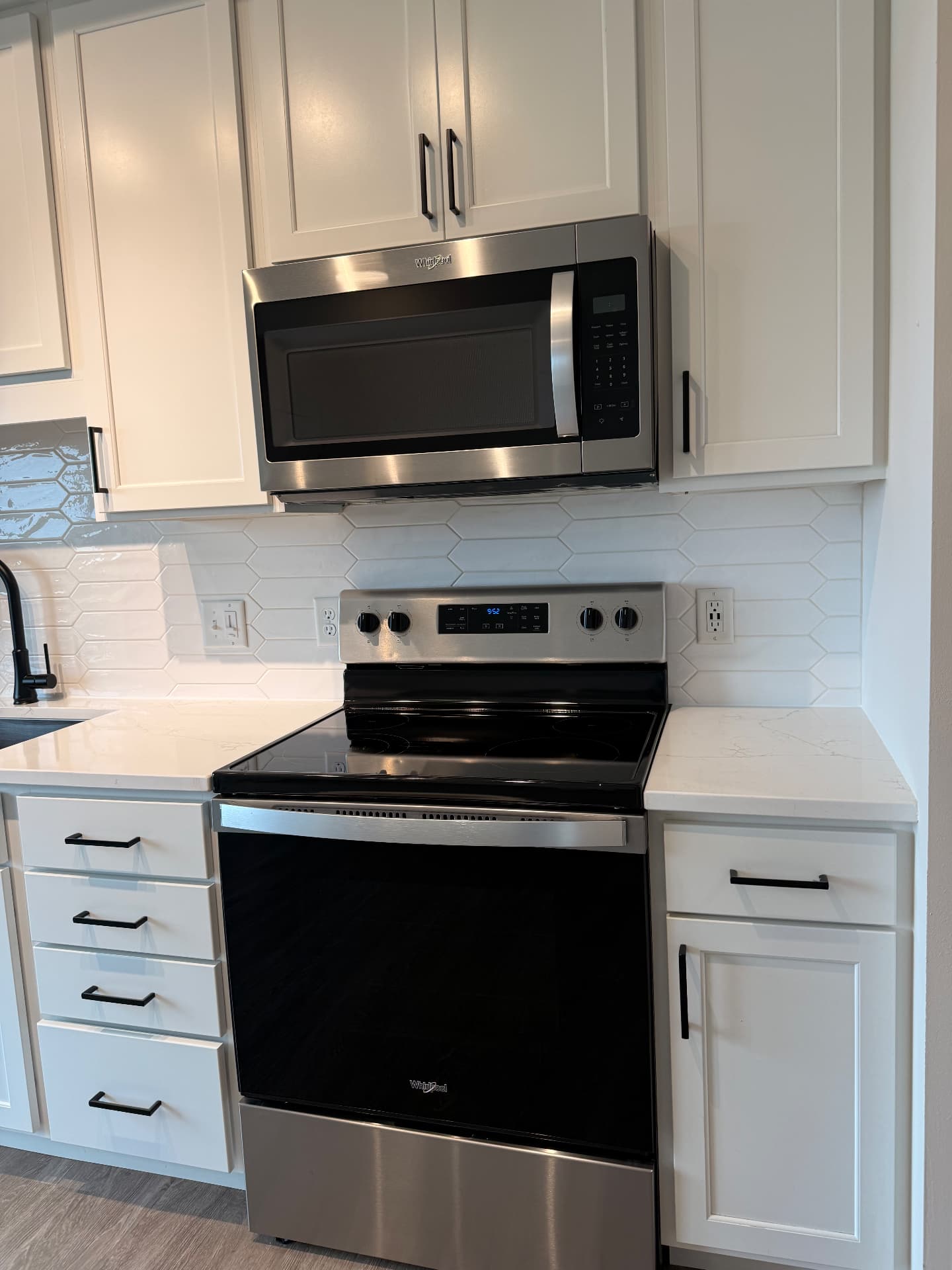 Gleaming stove, microwave and backsplash