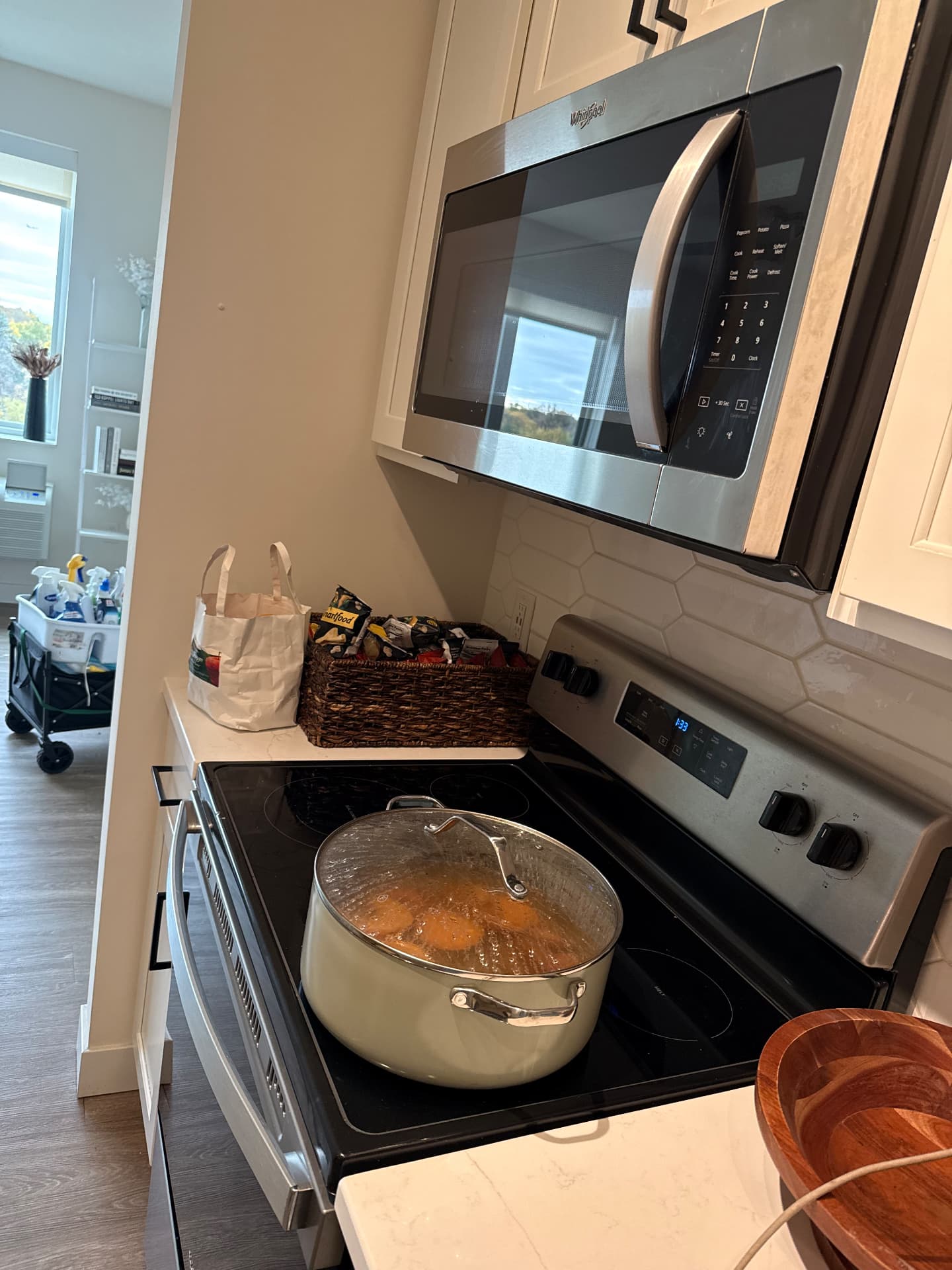 Pot simmering on a clean cooktop after a kitchen clean