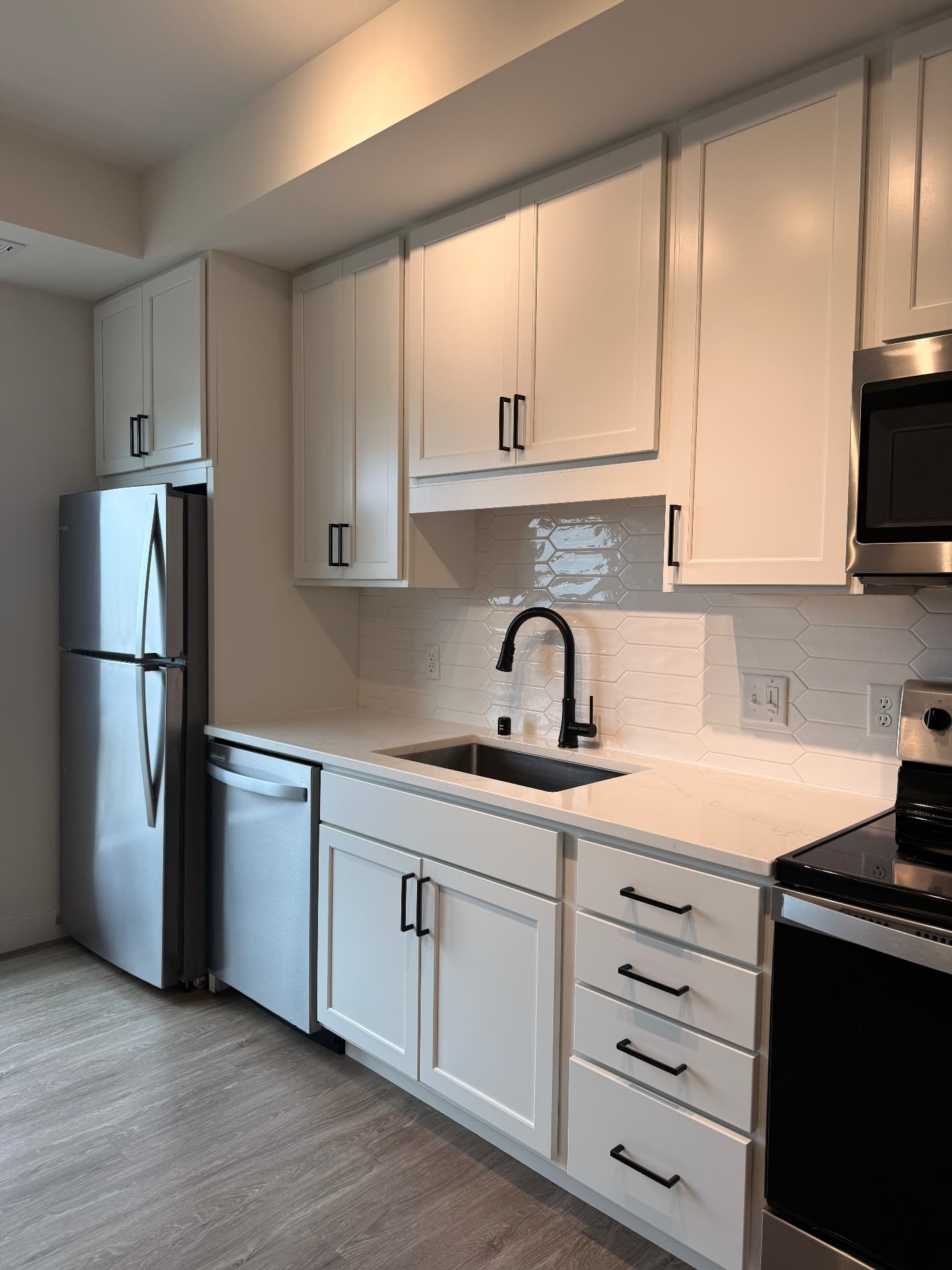 Spotless white kitchen with stainless appliances